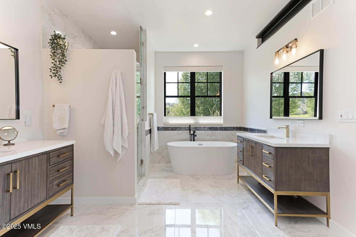 207 Aidan Road Eagle, CO 81631 - Photo 25 of 51 a large bathroom with a double vanity sink a mirror and a bathtub