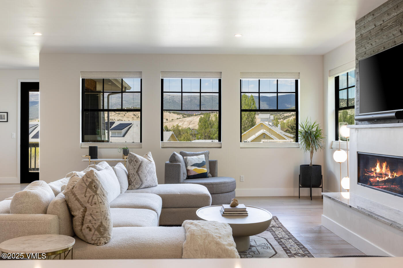 207 Aidan Road Eagle, CO 81631 - Photo 5 of 51 a living room with furniture a fireplace and a flat screen tv