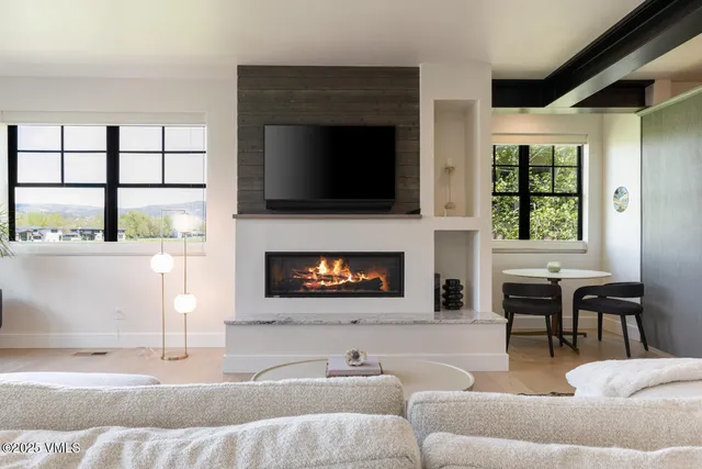 a living room with furniture fireplace and a flat screen tv