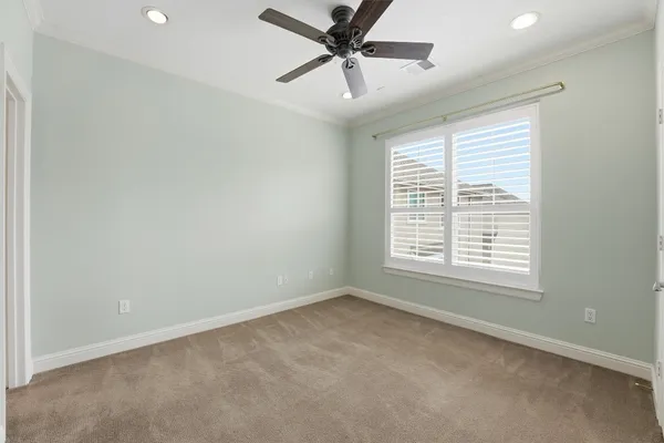 a view of a livingroom with a ceiling fan and window