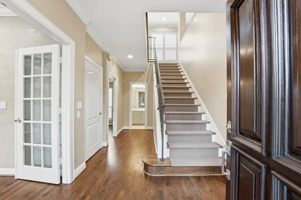 a view of a room with wooden floor and windows
