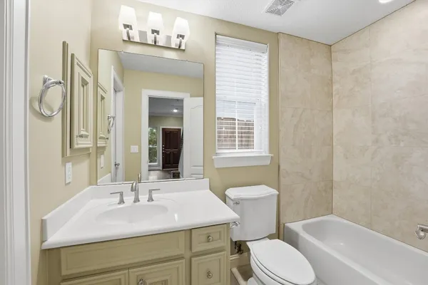 a bathroom with a sink toilet a mirror and shower