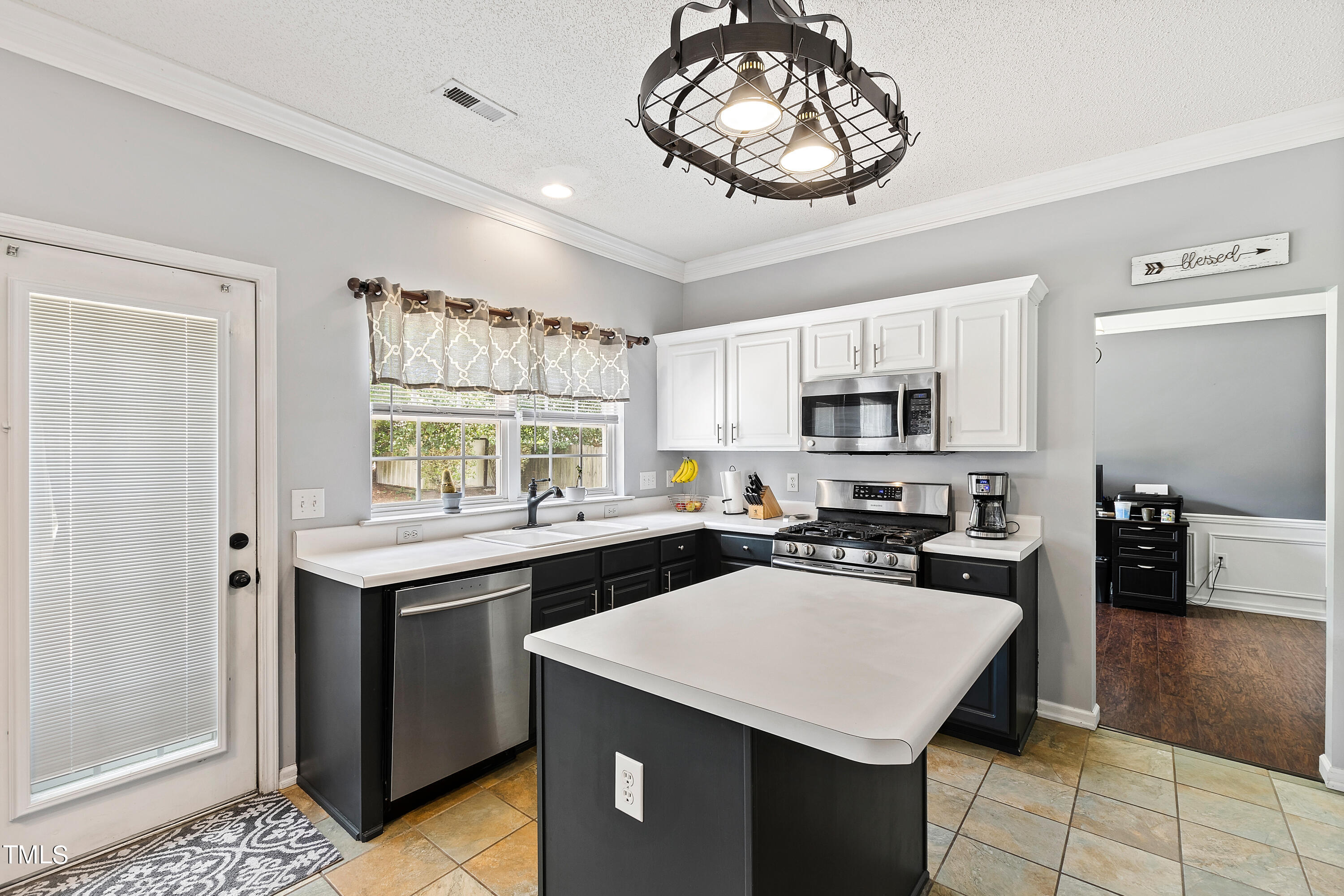 401 New Timber Path Apex, NC 27502 - Photo 12 of 38 a kitchen with a stove a sink a window and dining table