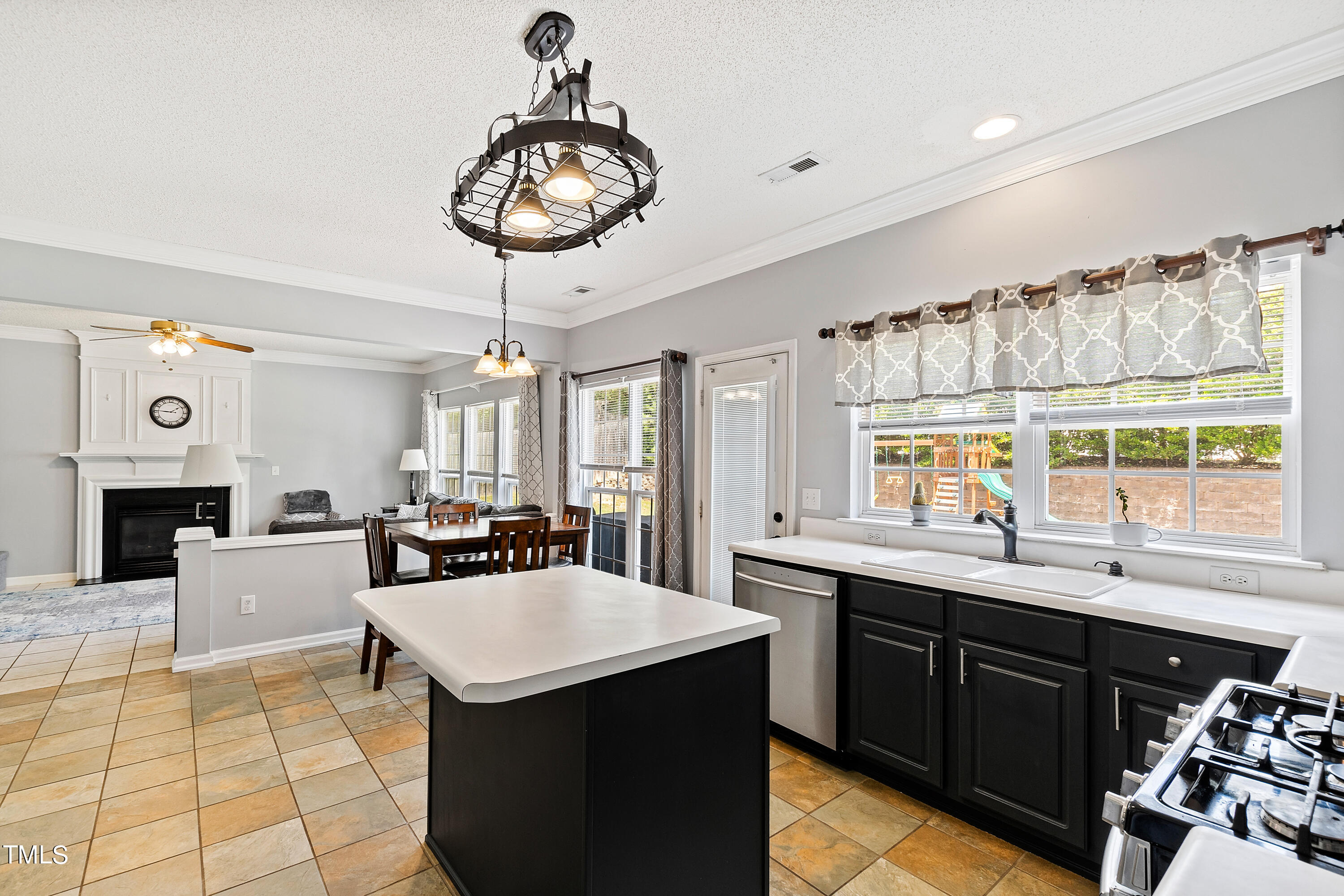 401 New Timber Path Apex, NC 27502 - Photo 15 of 38 a kitchen with a sink a counter space and dining table