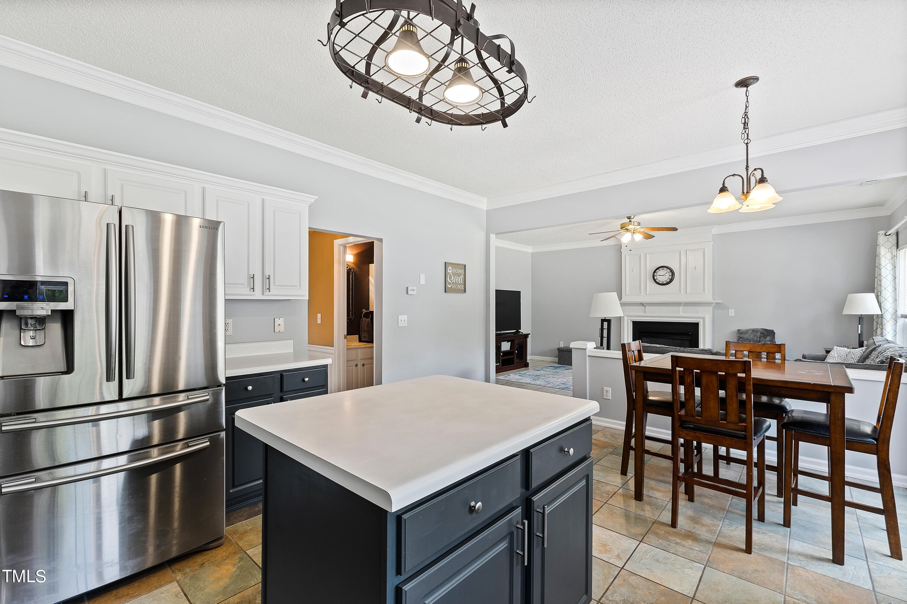 401 New Timber Path Apex, NC 27502 - Photo 16 of 38 a kitchen with stainless steel appliances a table chairs and entryway