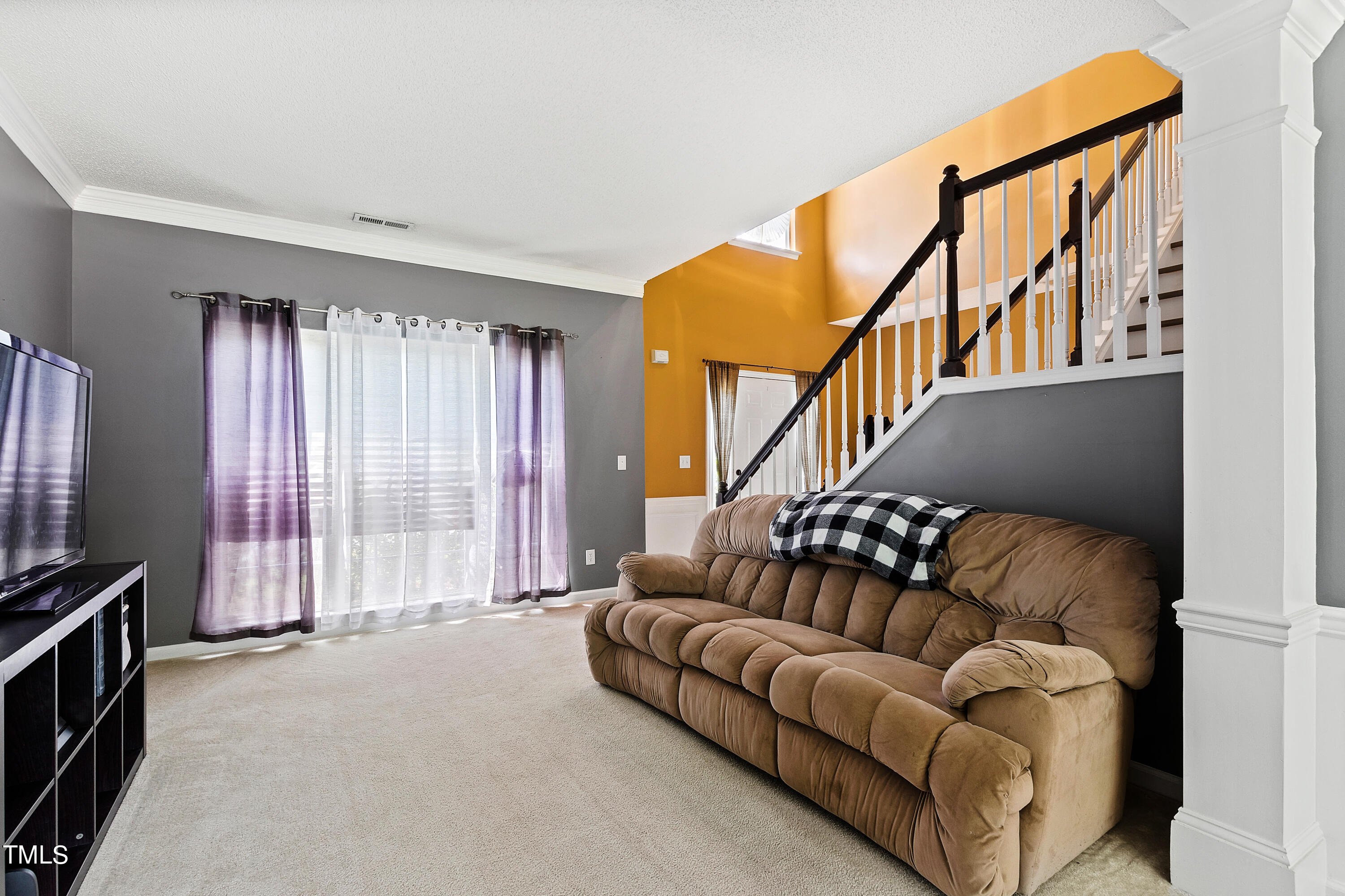 401 New Timber Path Apex, NC 27502 - Photo 18 of 38 a living room with furniture fireplace and a flat screen tv