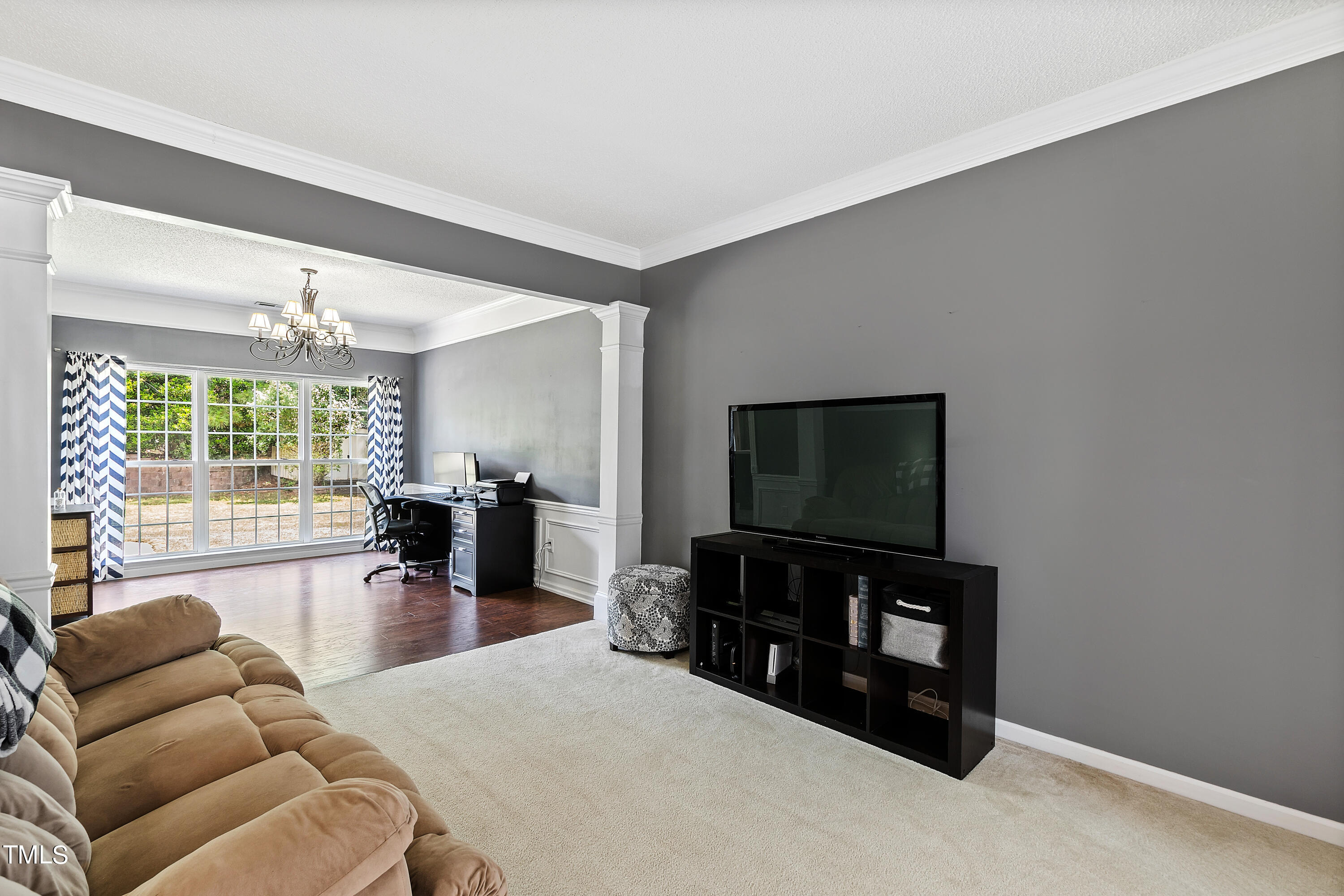 401 New Timber Path Apex, NC 27502 - Photo 19 of 38 a living room with furniture and a flat screen tv