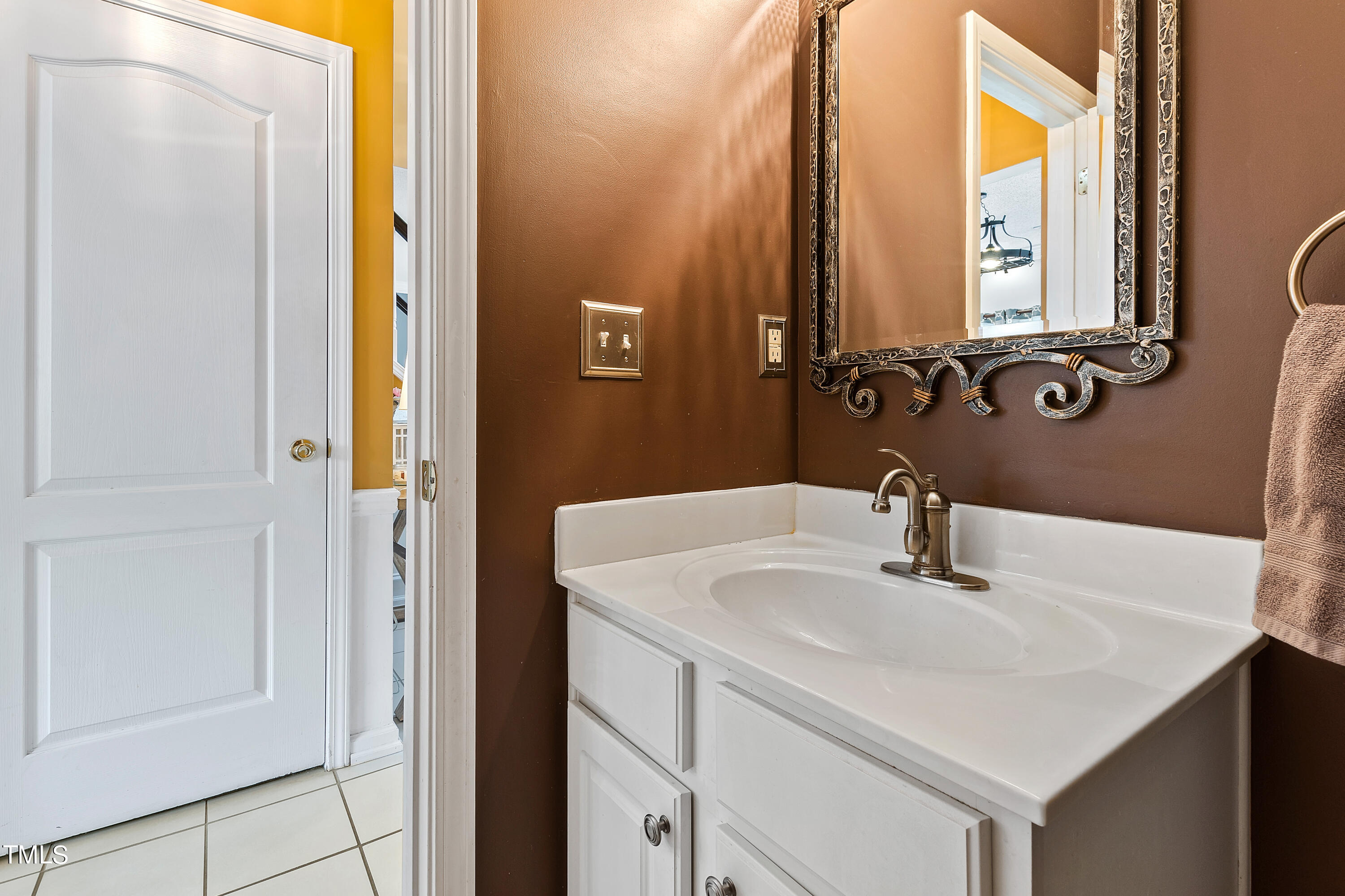 401 New Timber Path Apex, NC 27502 - Photo 20 of 38 a bathroom with a sink and a mirror