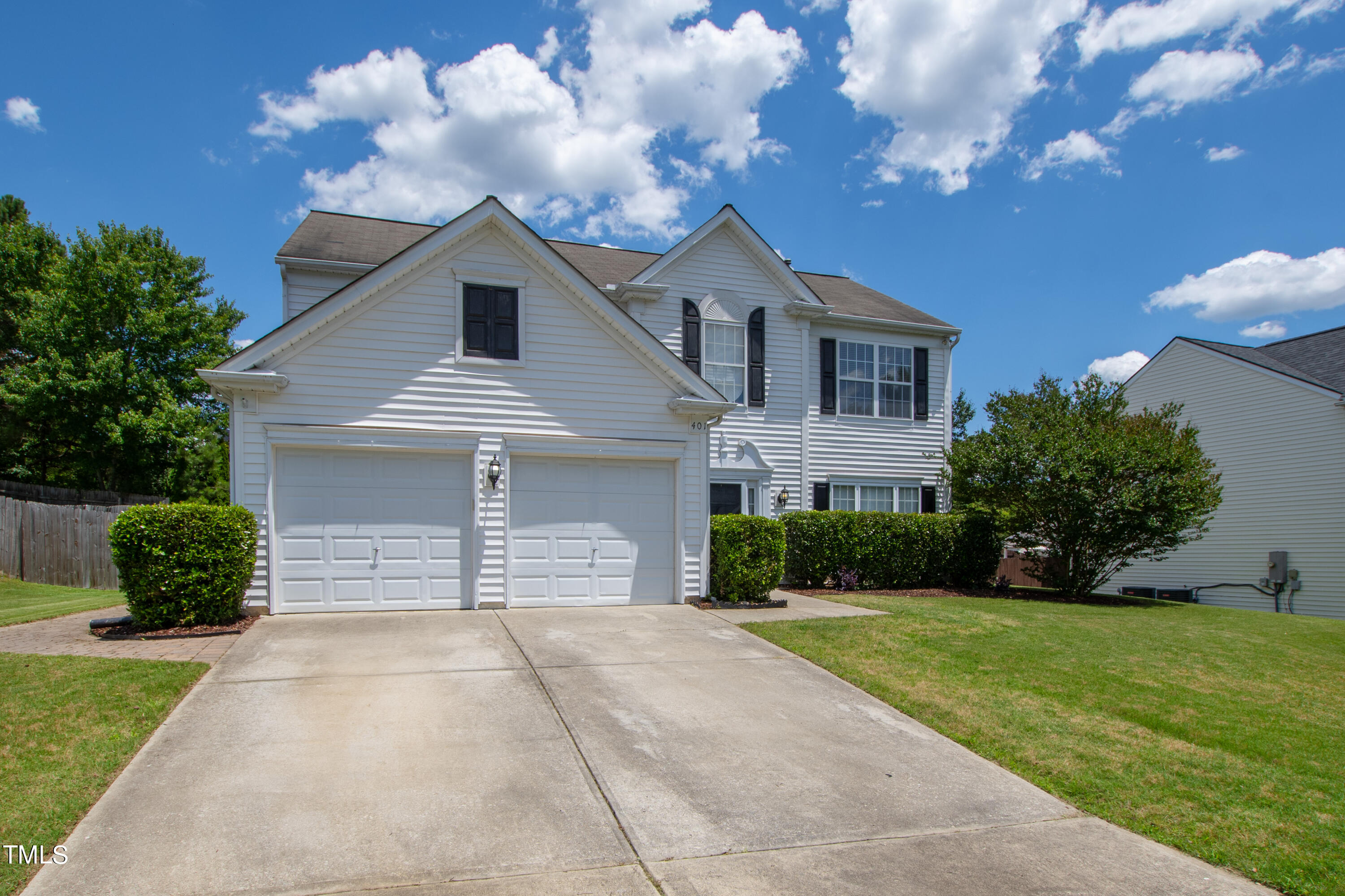 401 New Timber Path Apex, NC 27502 - Photo 2 of 38 a front view of a house with a yard and garage
