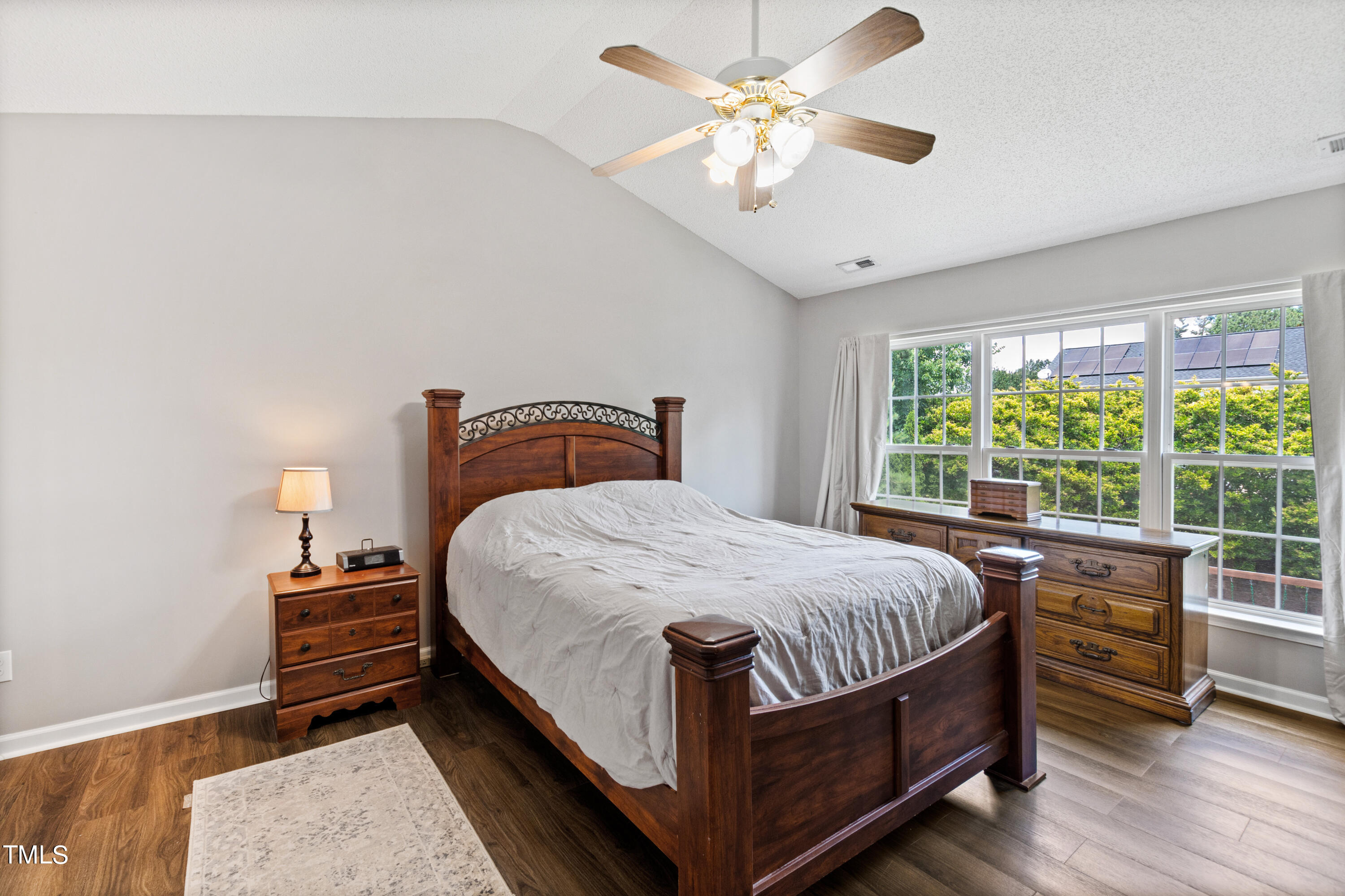 401 New Timber Path Apex, NC 27502 - Photo 21 of 38 a bedroom with a bed chandelier and a window