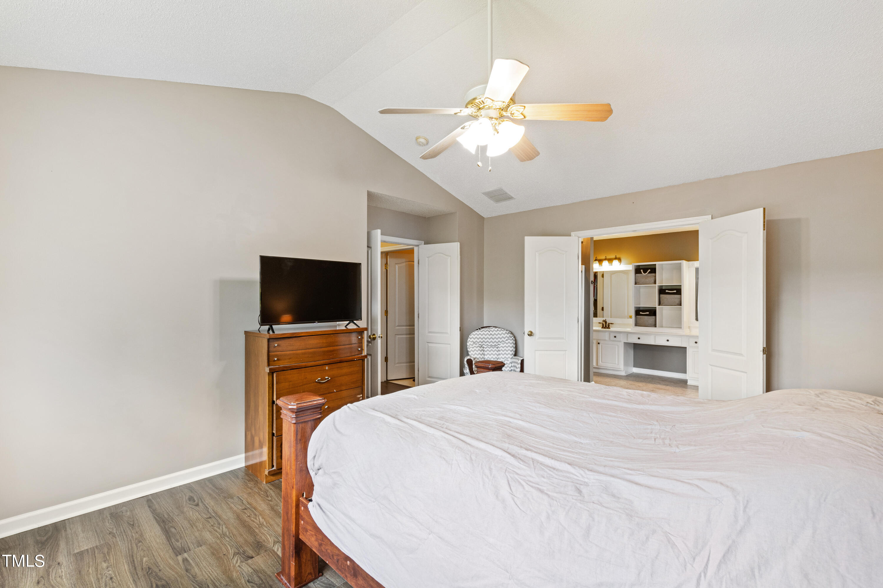 401 New Timber Path Apex, NC 27502 - Photo 22 of 38 a bedroom with a bed and a flat screen tv