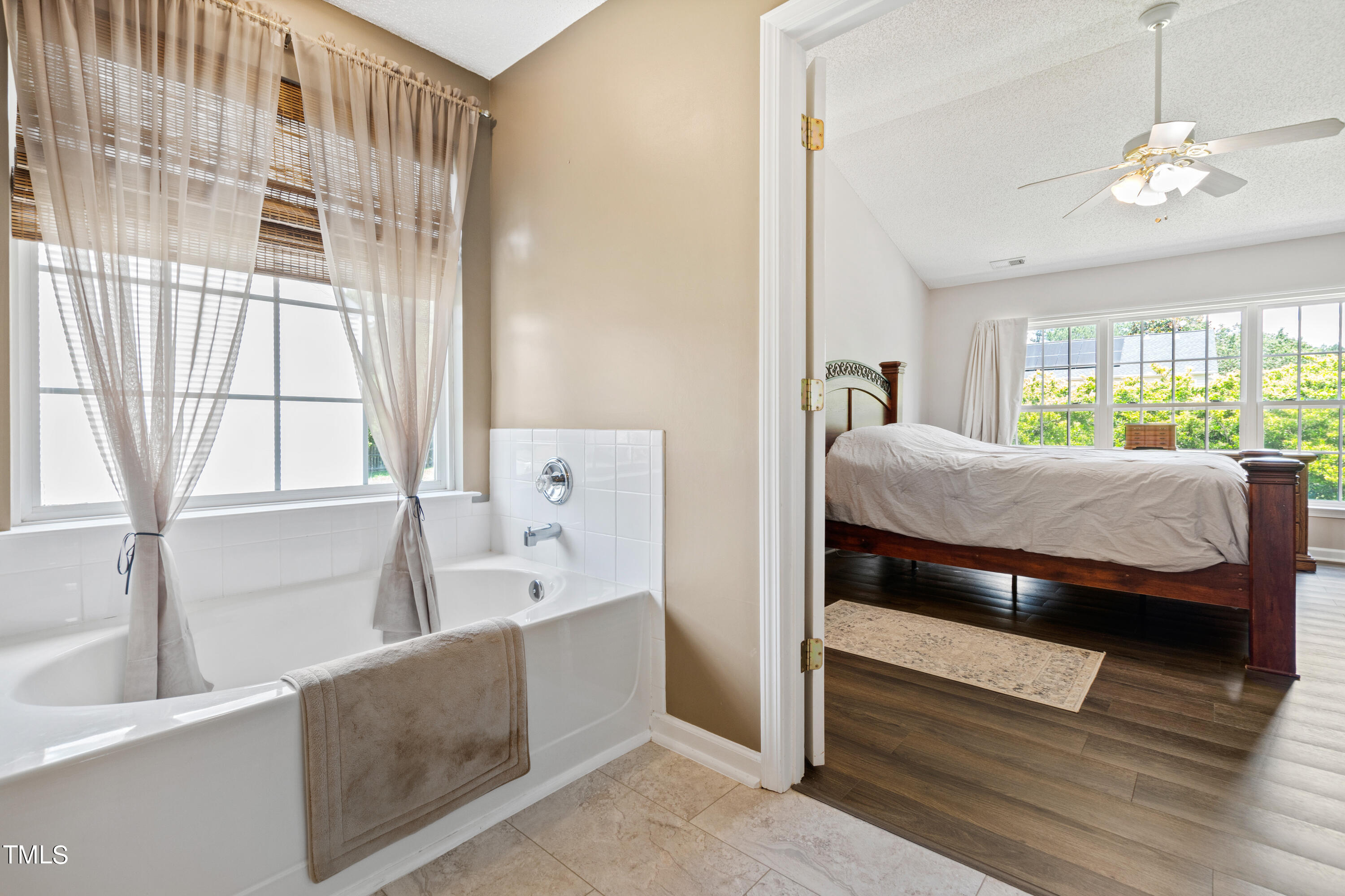401 New Timber Path Apex, NC 27502 - Photo 23 of 38 a bedroom with a bed and a large window