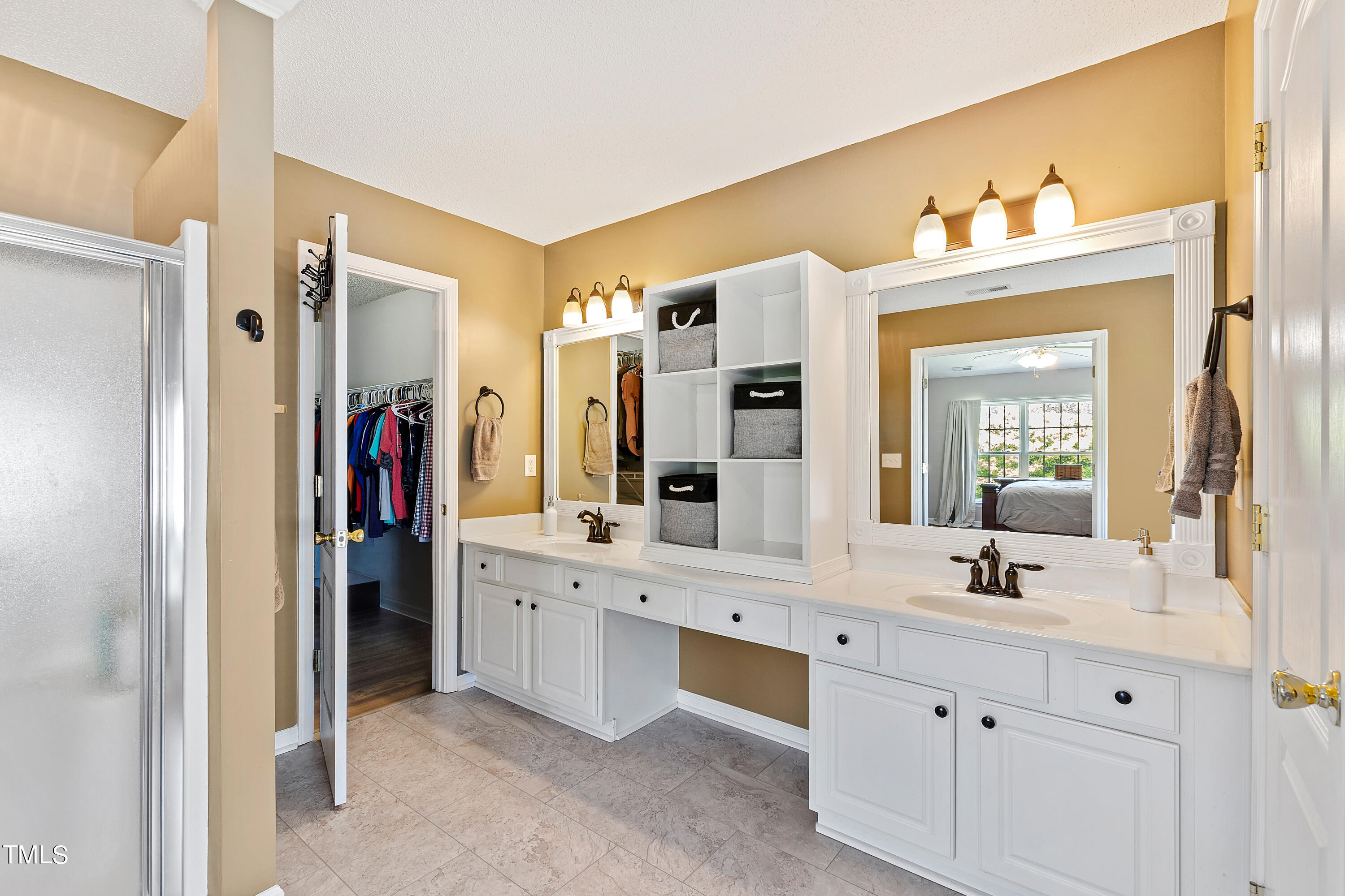 401 New Timber Path Apex, NC 27502 - Photo 24 of 38 a bathroom with a double vanity sink and a mirror