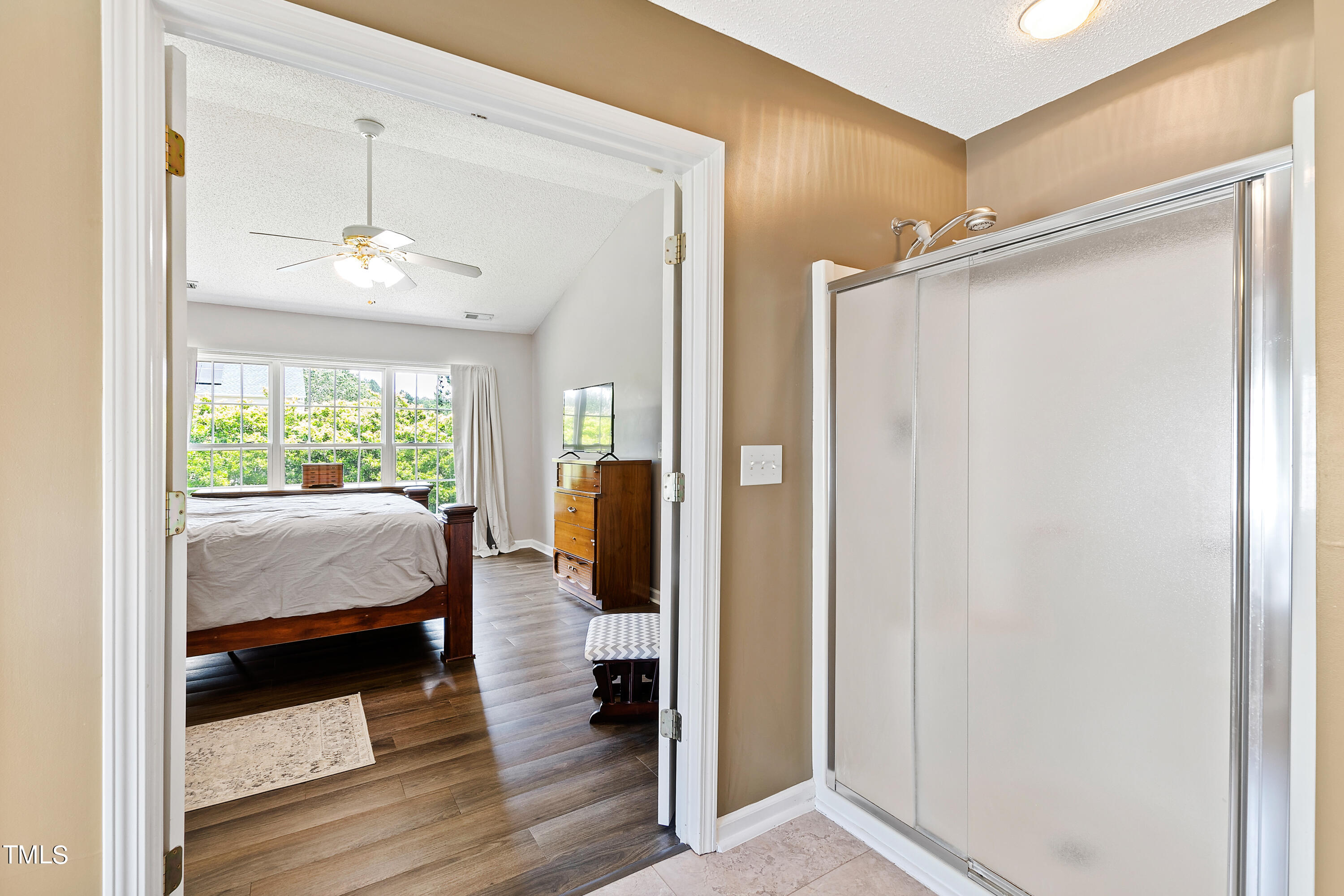 401 New Timber Path Apex, NC 27502 - Photo 25 of 38 a bedroom with a bed and a mirror