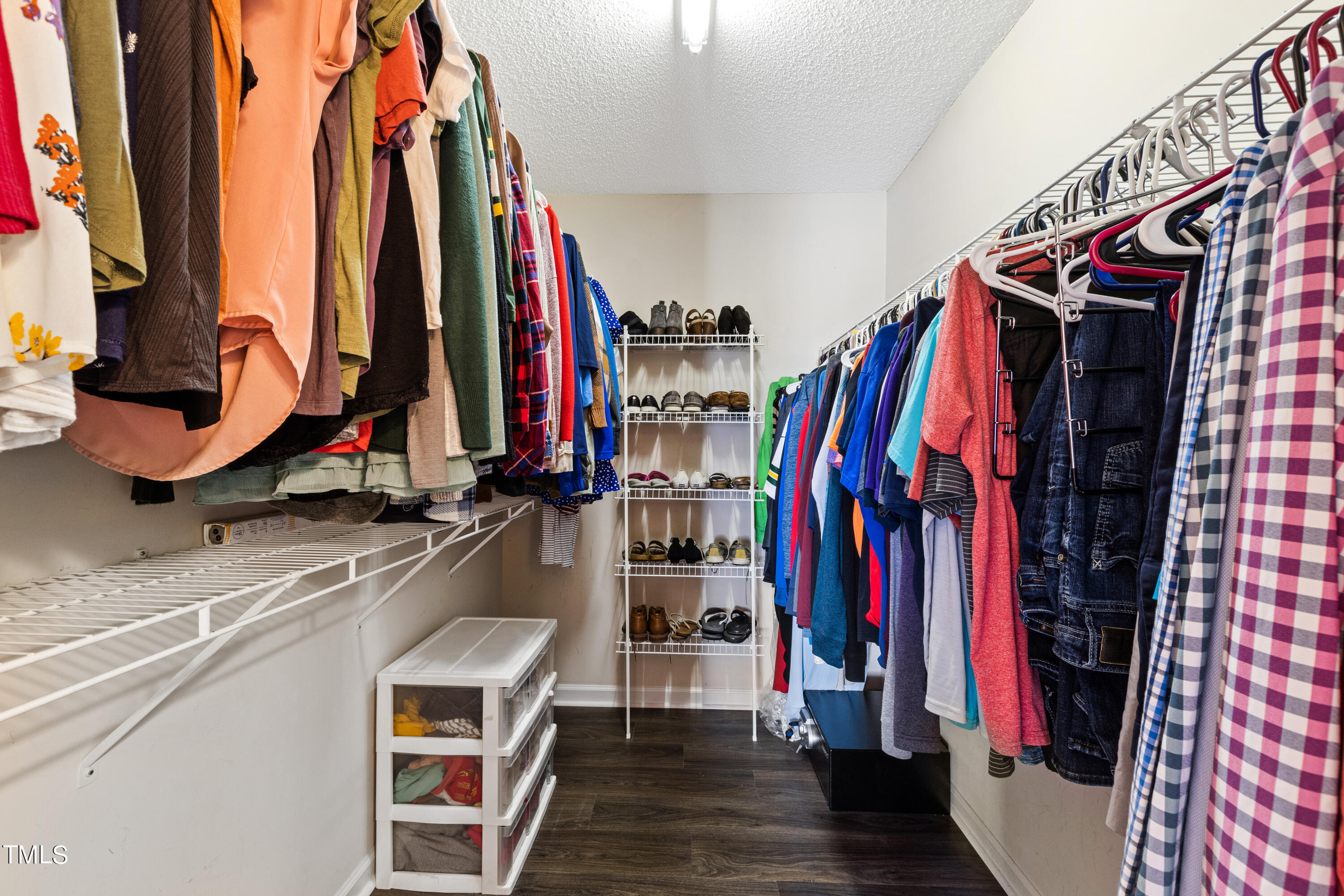 401 New Timber Path Apex, NC 27502 - Photo 26 of 38 a view of walk in closet with clothes