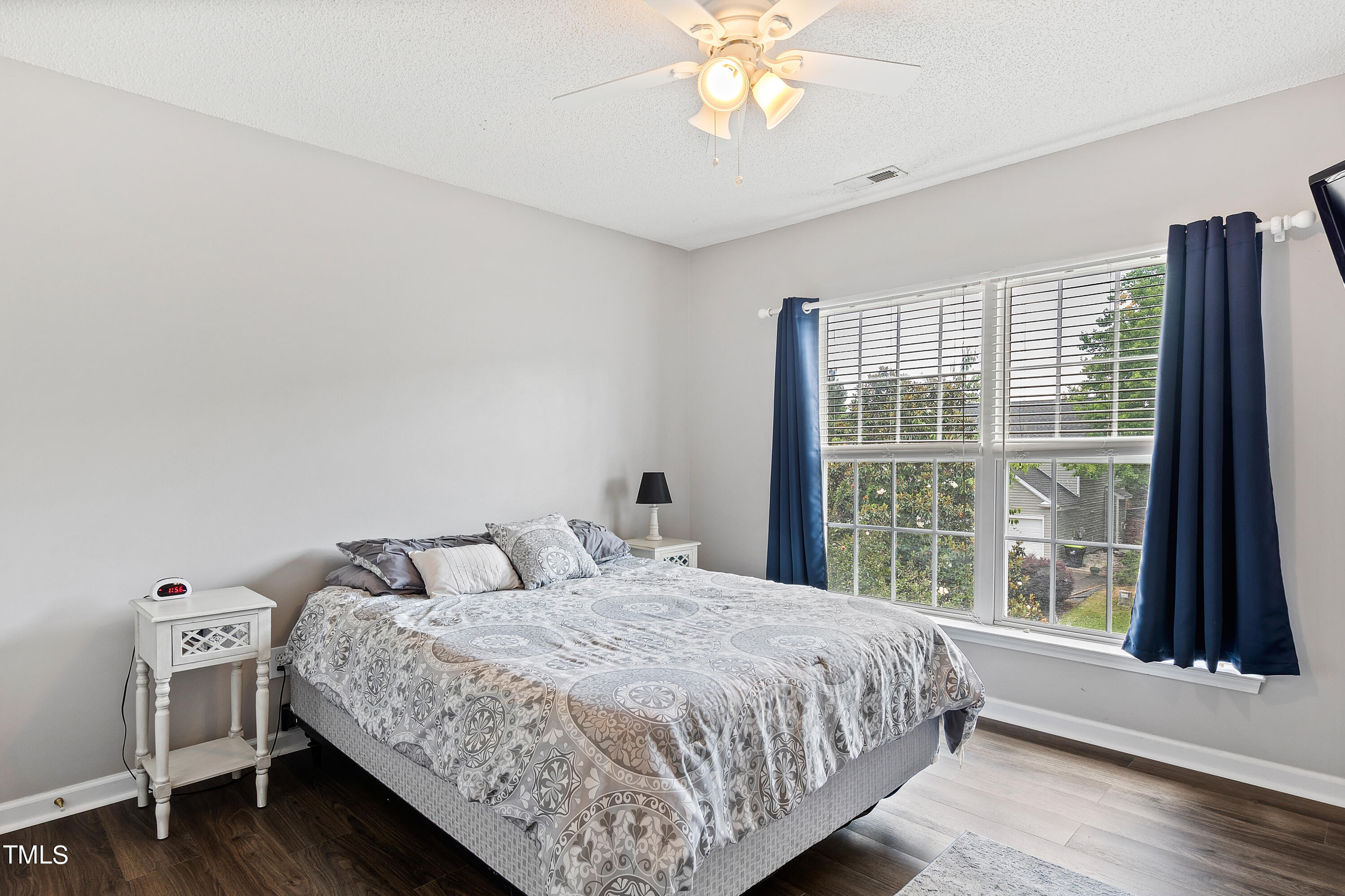401 New Timber Path Apex, NC 27502 - Photo 27 of 38 a bedroom with a large bed and a large window