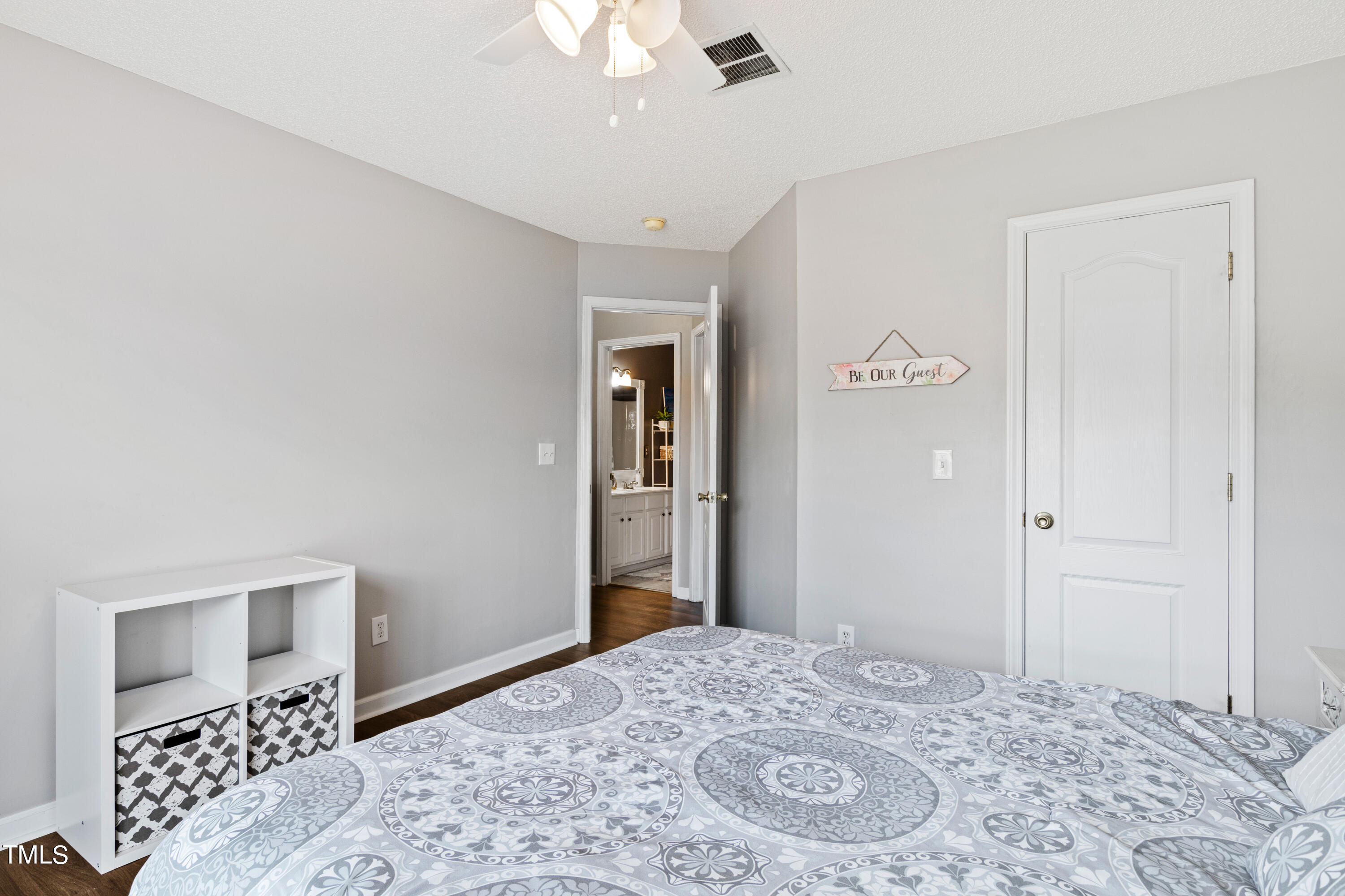 401 New Timber Path Apex, NC 27502 - Photo 28 of 38 a bedroom with a bed and a dresser
