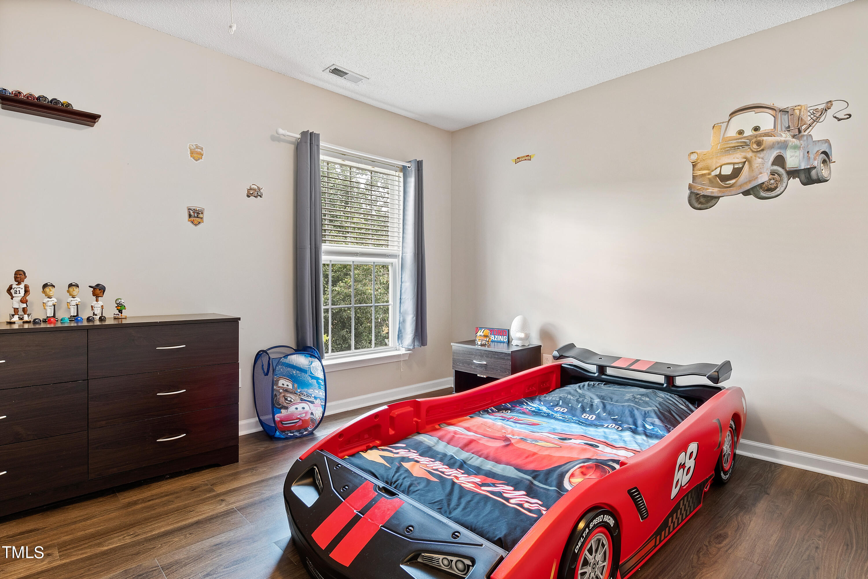 401 New Timber Path Apex, NC 27502 - Photo 29 of 38 a bedroom with a bed and wooden floor