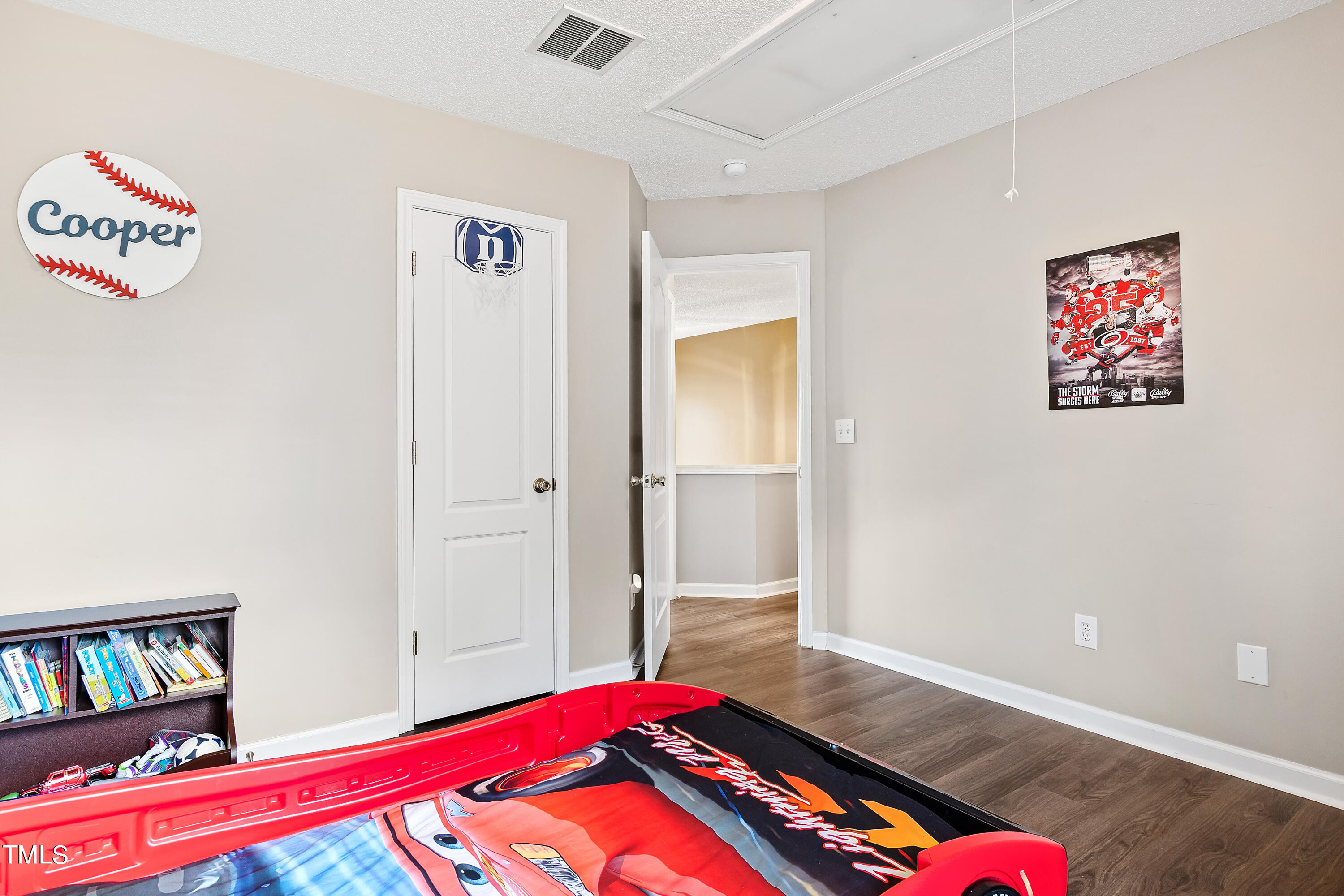 401 New Timber Path Apex, NC 27502 - Photo 30 of 38 a bedroom with a bed and a book shelf