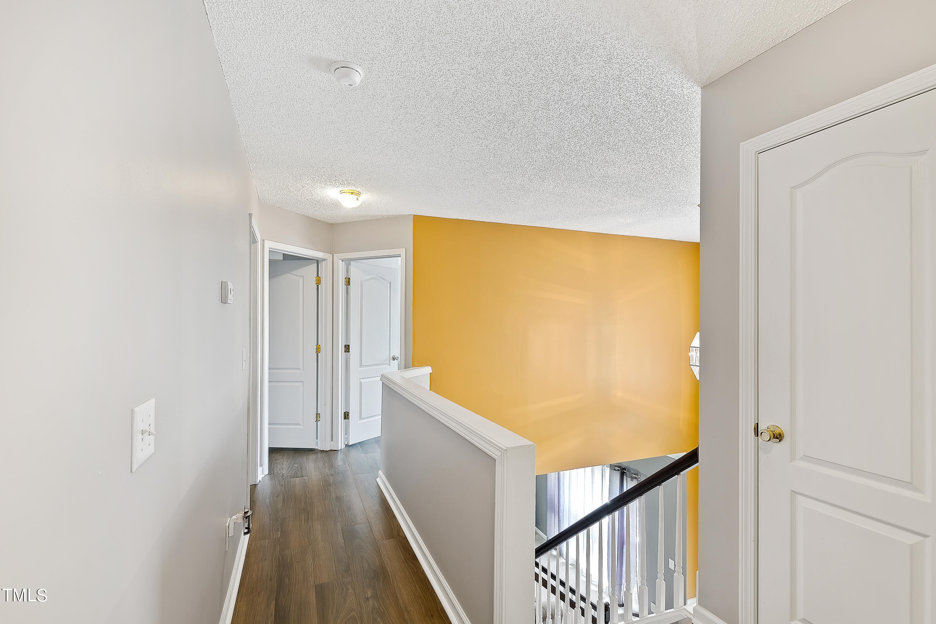 401 New Timber Path Apex, NC 27502 - Photo 34 of 38 a view of a hallway with wooden floor and staircase