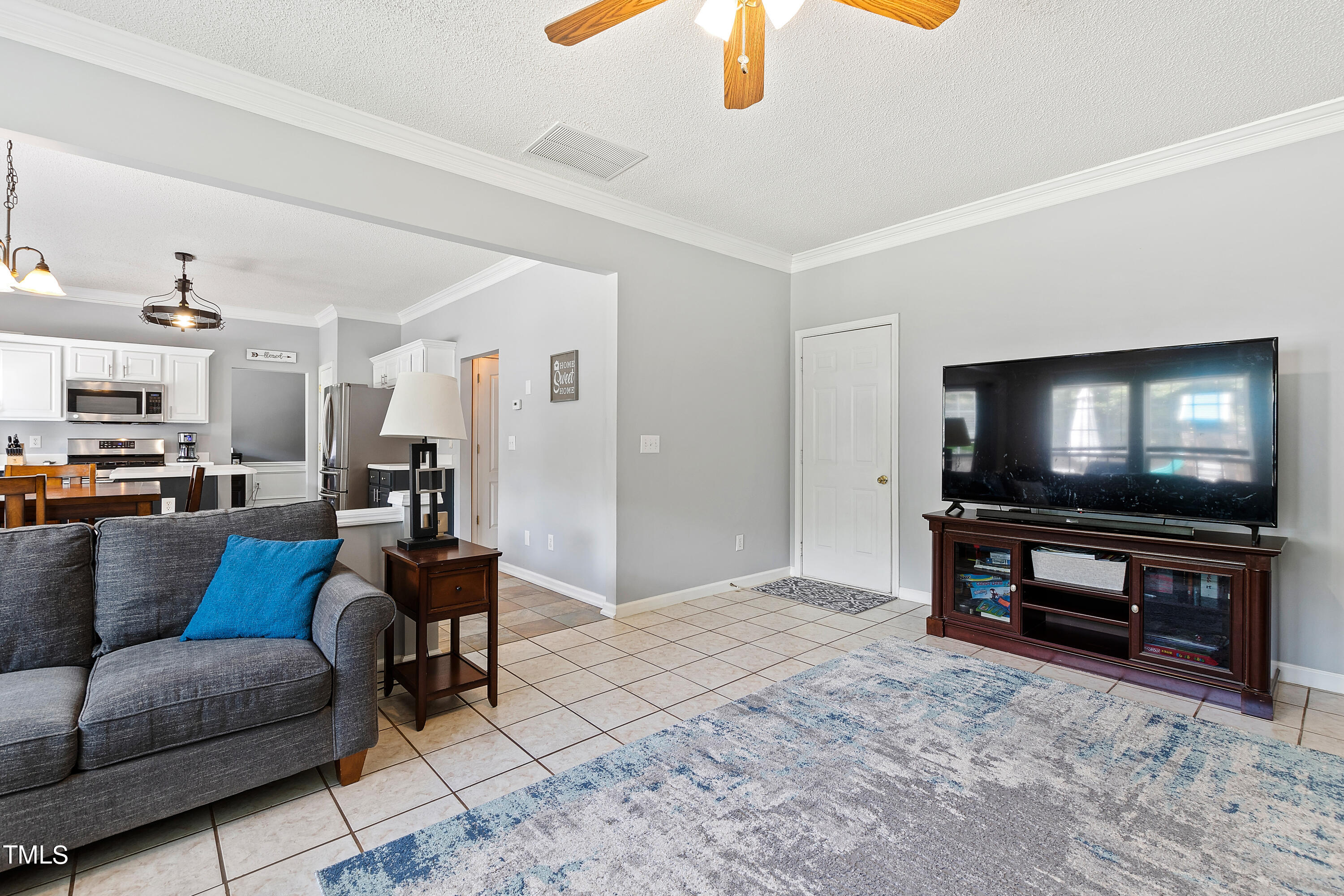 401 New Timber Path Apex, NC 27502 - Photo 9 of 38 a living room with furniture and a flat screen tv