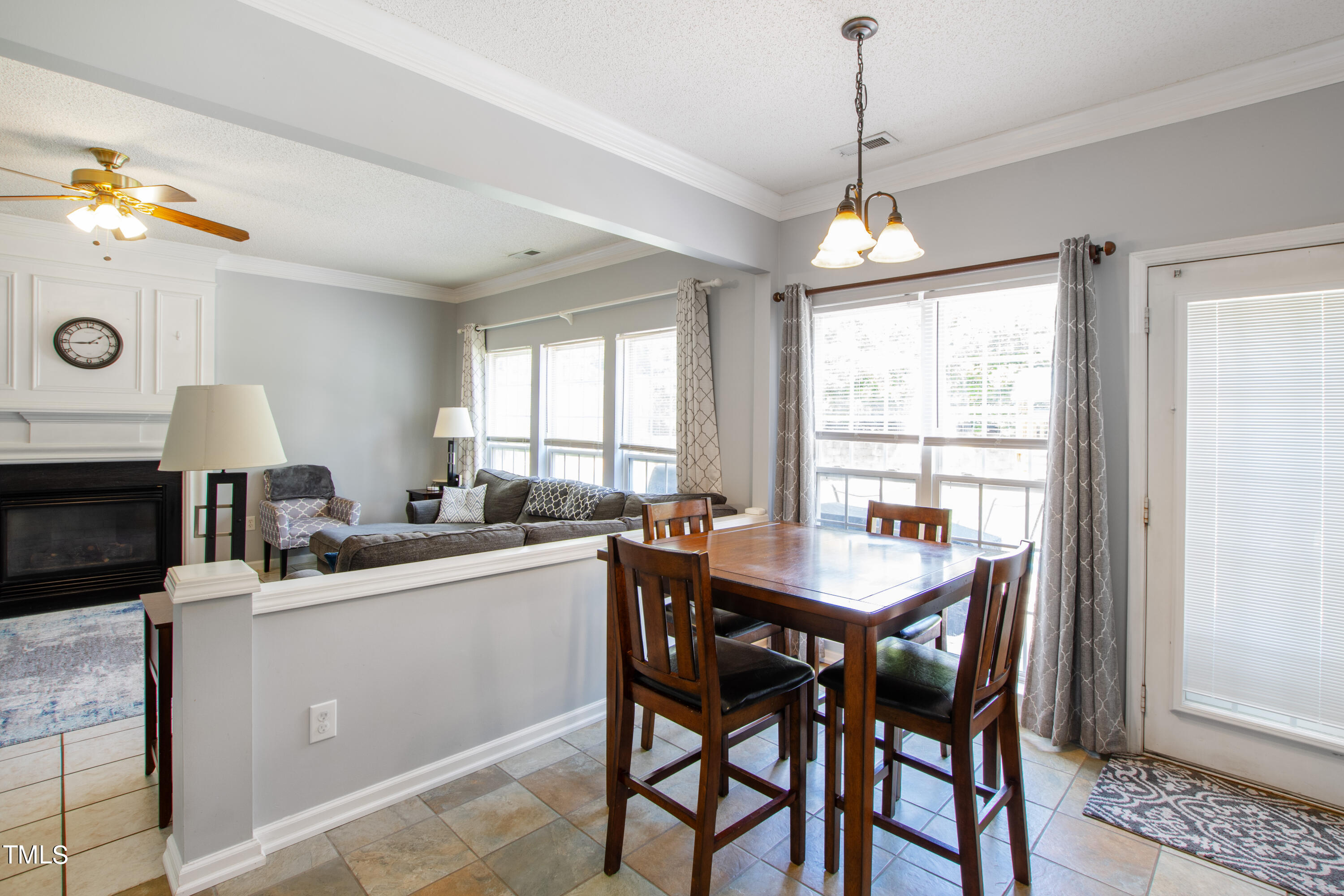 401 New Timber Path Apex, NC 27502 - Photo 10 of 38 a kitchen with a dining table chairs sink and cabinets