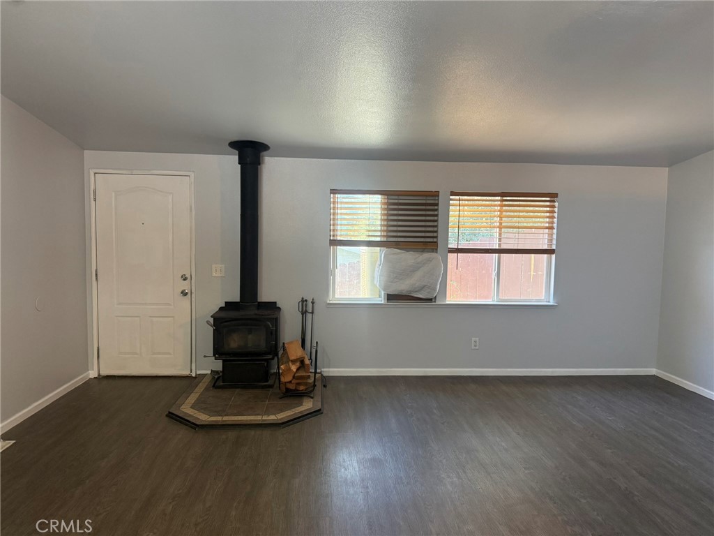 6845 Floyd Way Nice, CA 95464 - Photo 15 of 59 an empty room with wooden floor and windows