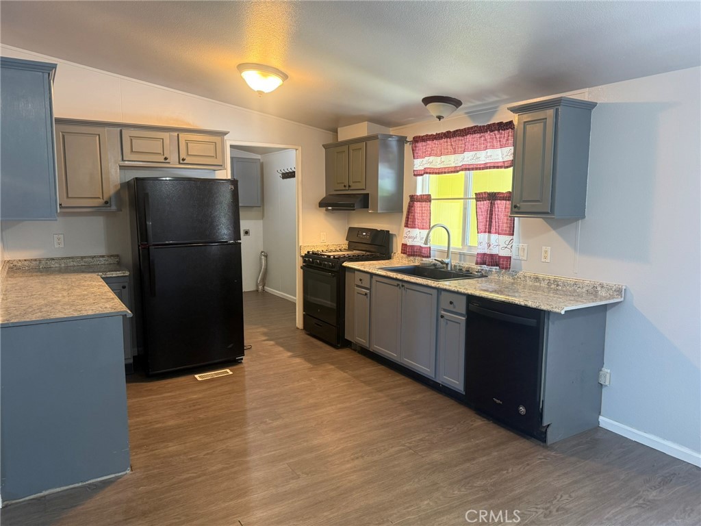 6845 Floyd Way Nice, CA 95464 - Photo 20 of 59 a kitchen with stainless steel appliances granite countertop a refrigerator a sink a stove and island