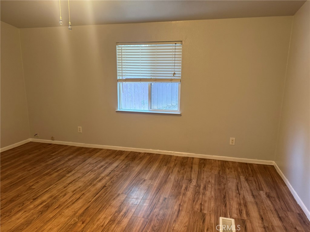 6845 Floyd Way Nice, CA 95464 - Photo 26 of 59 a view of an empty room with wooden floor and a window