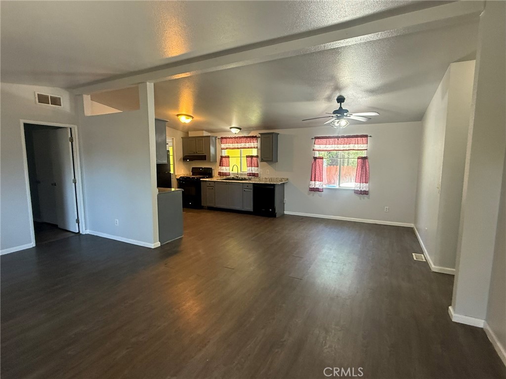 6845 Floyd Way Nice, CA 95464 - Photo 31 of 59 an empty room with wooden floor and windows
