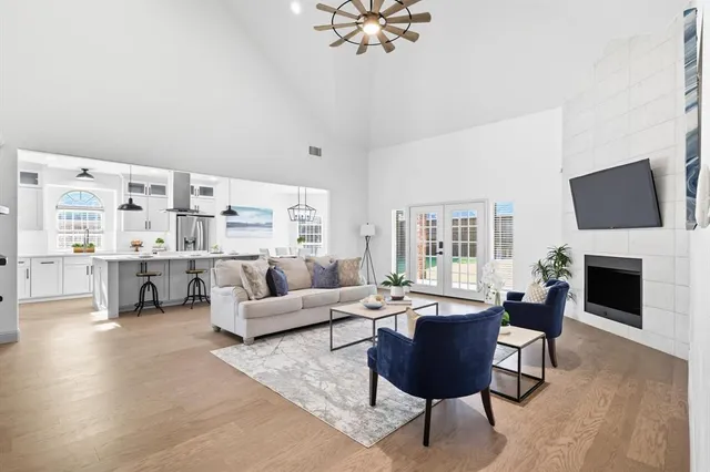 a living room with furniture a fireplace and a flat screen tv