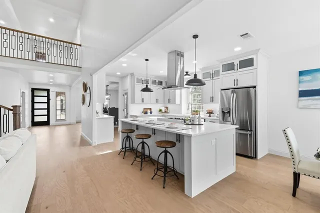 a large kitchen with a table and chairs