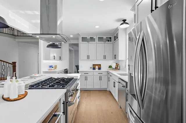a kitchen with sink cabinets and stainless steel appliances