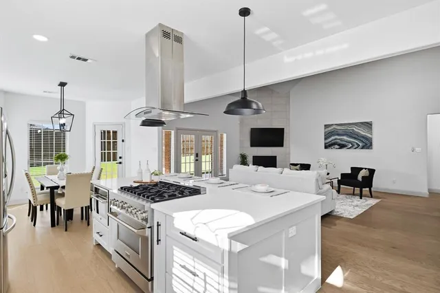 a kitchen with white cabinets and appliances