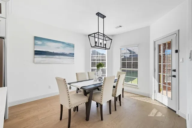 a kitchen with stainless steel appliances kitchen island granite countertop a stove a sink and chairs