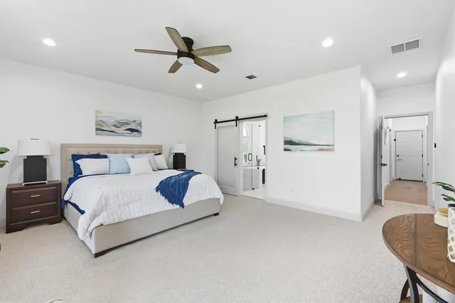 a bedroom with a bed and a couch