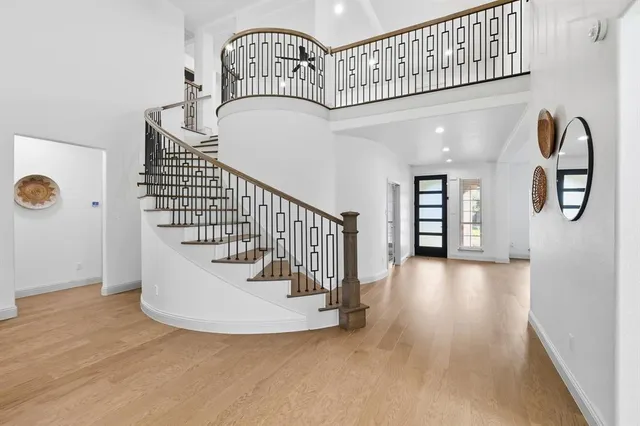 a view of entryway and hall with wooden floor