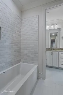 a spacious bathroom with a bathtub and a sink