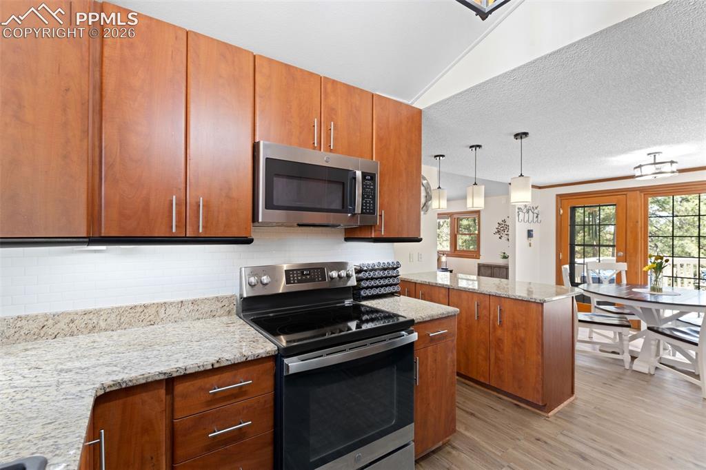 1851 Buttercup Road Elizabeth, CO 80107 - Photo 23 of 47 a kitchen with granite countertop wooden cabinets and stainless steel appliances