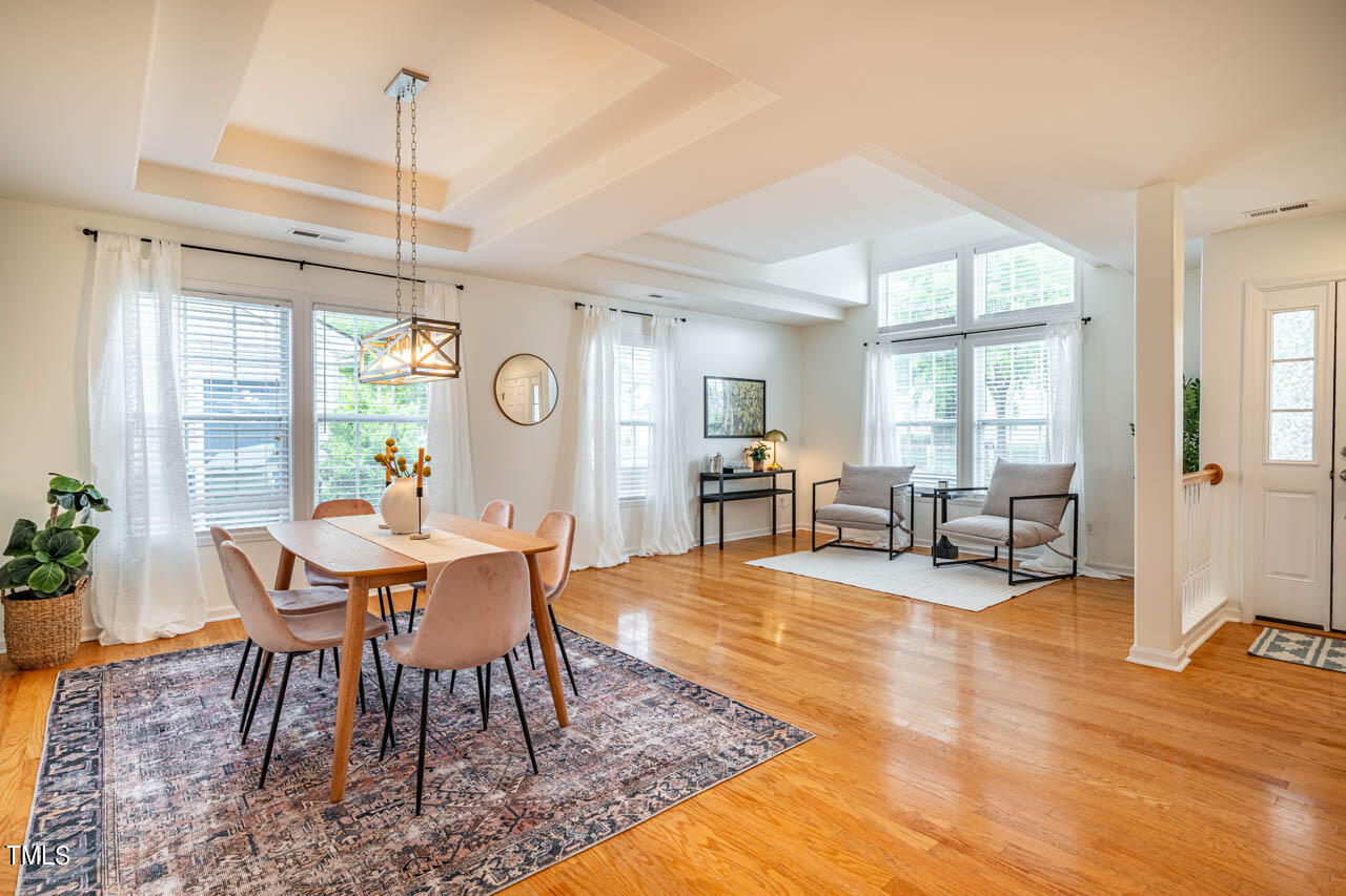1314 Mallory Lane Durham, NC 27713 - Photo 11 of 47 a dining room with furniture a chandelier and wooden floor