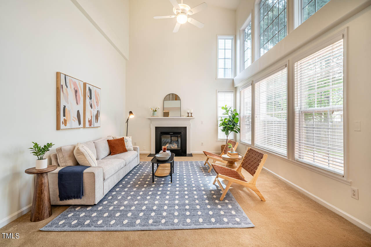 1314 Mallory Lane Durham, NC 27713 - Photo 14 of 47 a living room with furniture a rug a large window and a fireplace