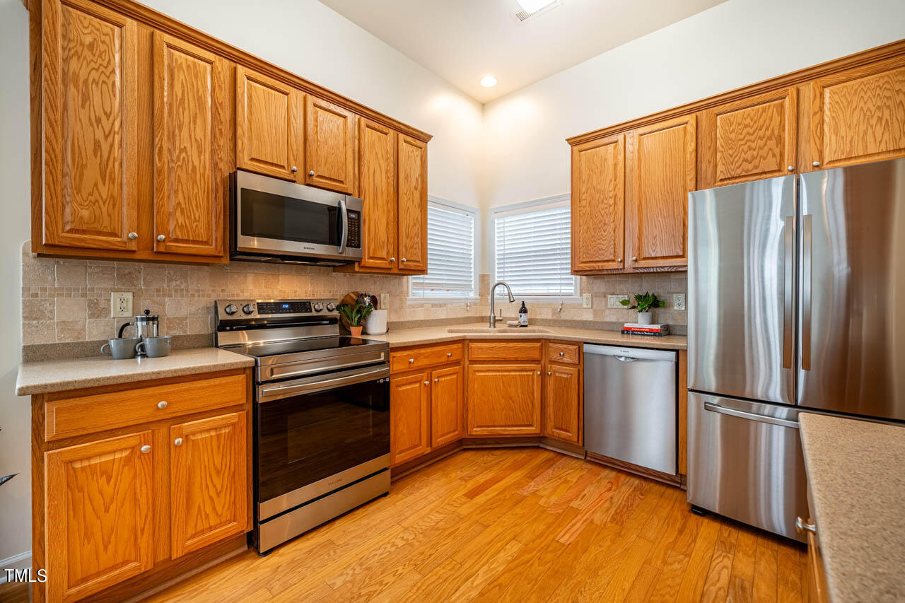 1314 Mallory Lane Durham, NC 27713 - Photo 19 of 47 a kitchen with stainless steel appliances granite countertop a refrigerator stove top oven and sink