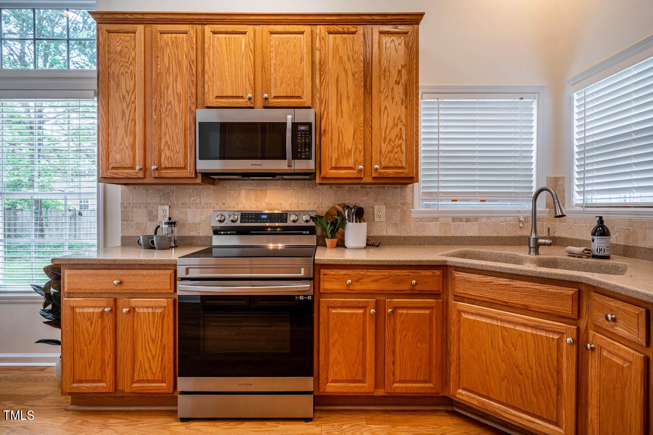 1314 Mallory Lane Durham, NC 27713 - Photo 20 of 47 a kitchen with granite countertop a stove and a sink