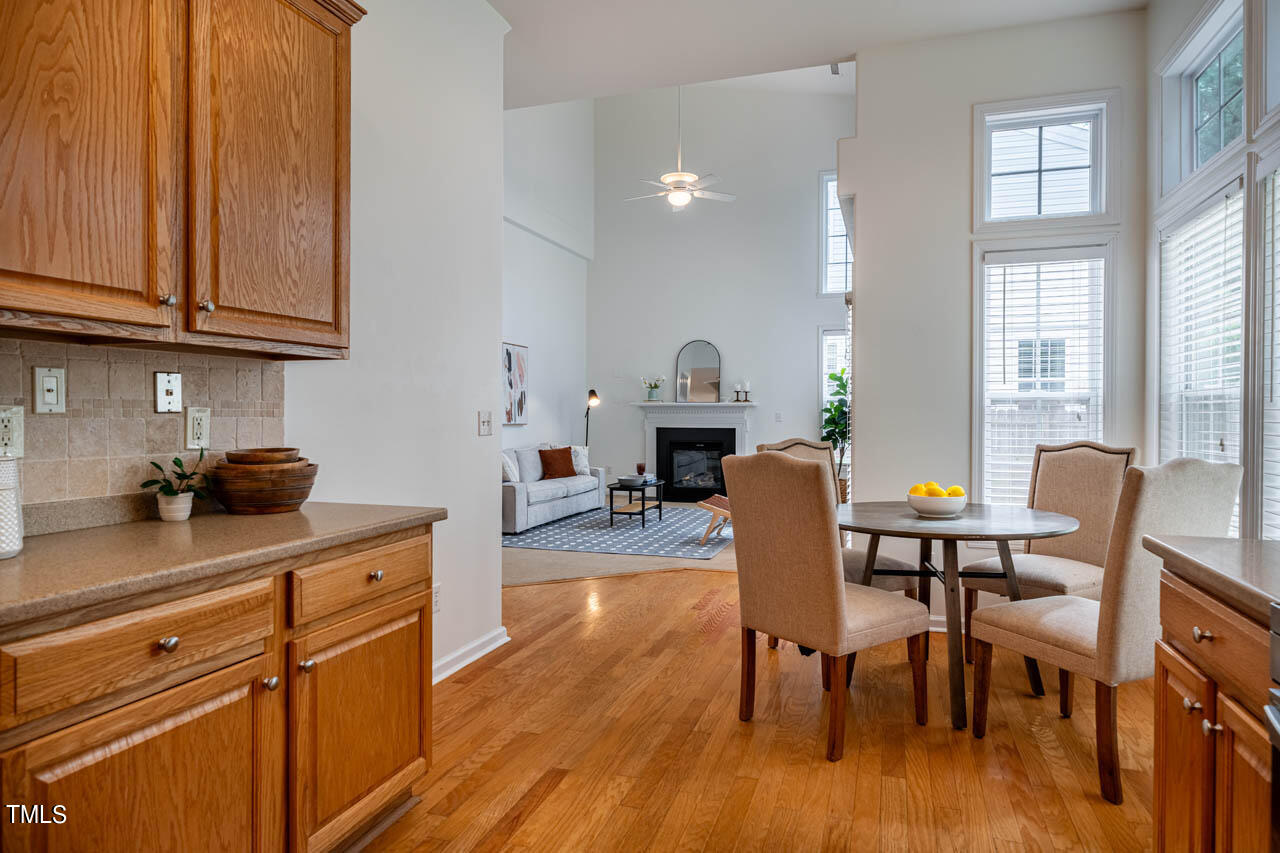 1314 Mallory Lane Durham, NC 27713 - Photo 22 of 47 a kitchen with stainless steel appliances granite countertop a table chairs stove a sink dishwasher and cabinets with wooden floor