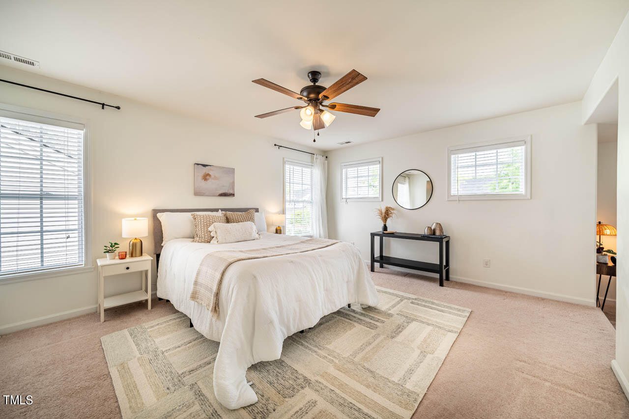 1314 Mallory Lane Durham, NC 27713 - Photo 28 of 47 a bedroom with a bed and a chandelier