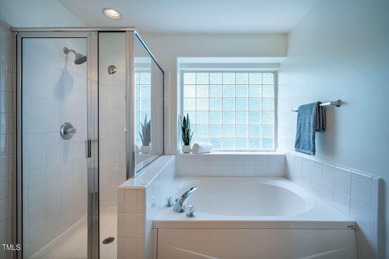 1314 Mallory Lane Durham, NC 27713 - Photo 32 of 47 a bathroom with a bathtub and a shower