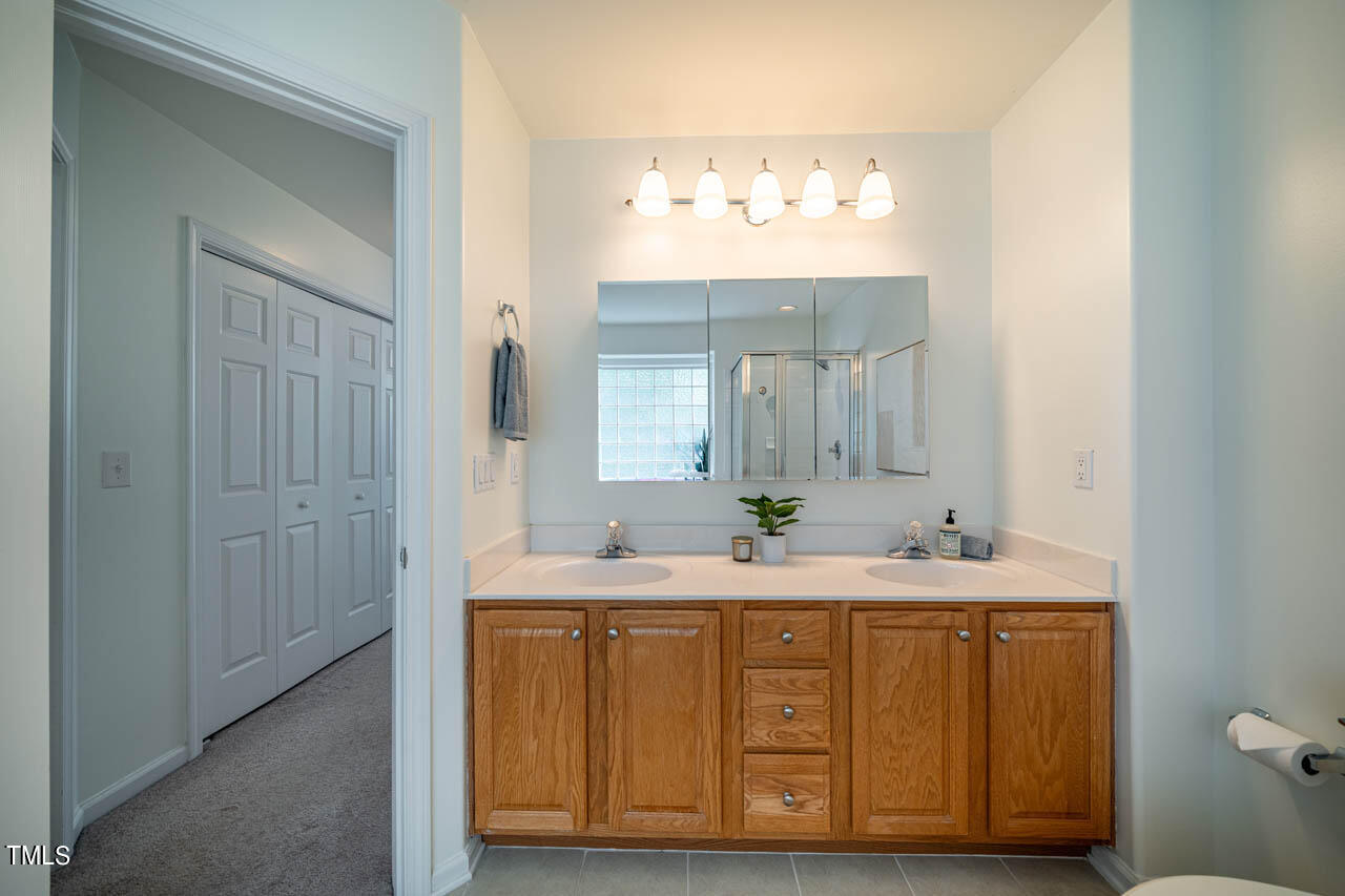 1314 Mallory Lane Durham, NC 27713 - Photo 33 of 47 a bathroom with a double vanity sink and a mirror