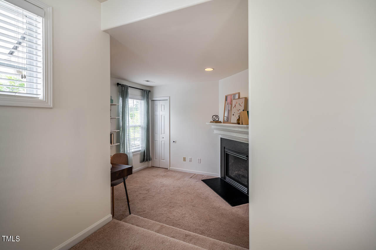 1314 Mallory Lane Durham, NC 27713 - Photo 34 of 47 a view of an empty room with a fireplace and a window