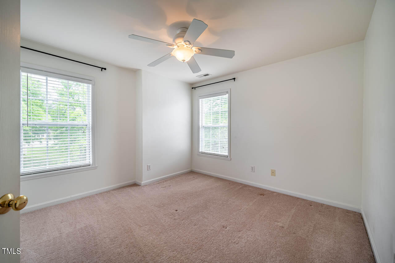 1314 Mallory Lane Durham, NC 27713 - Photo 37 of 47 an empty room with windows and fan