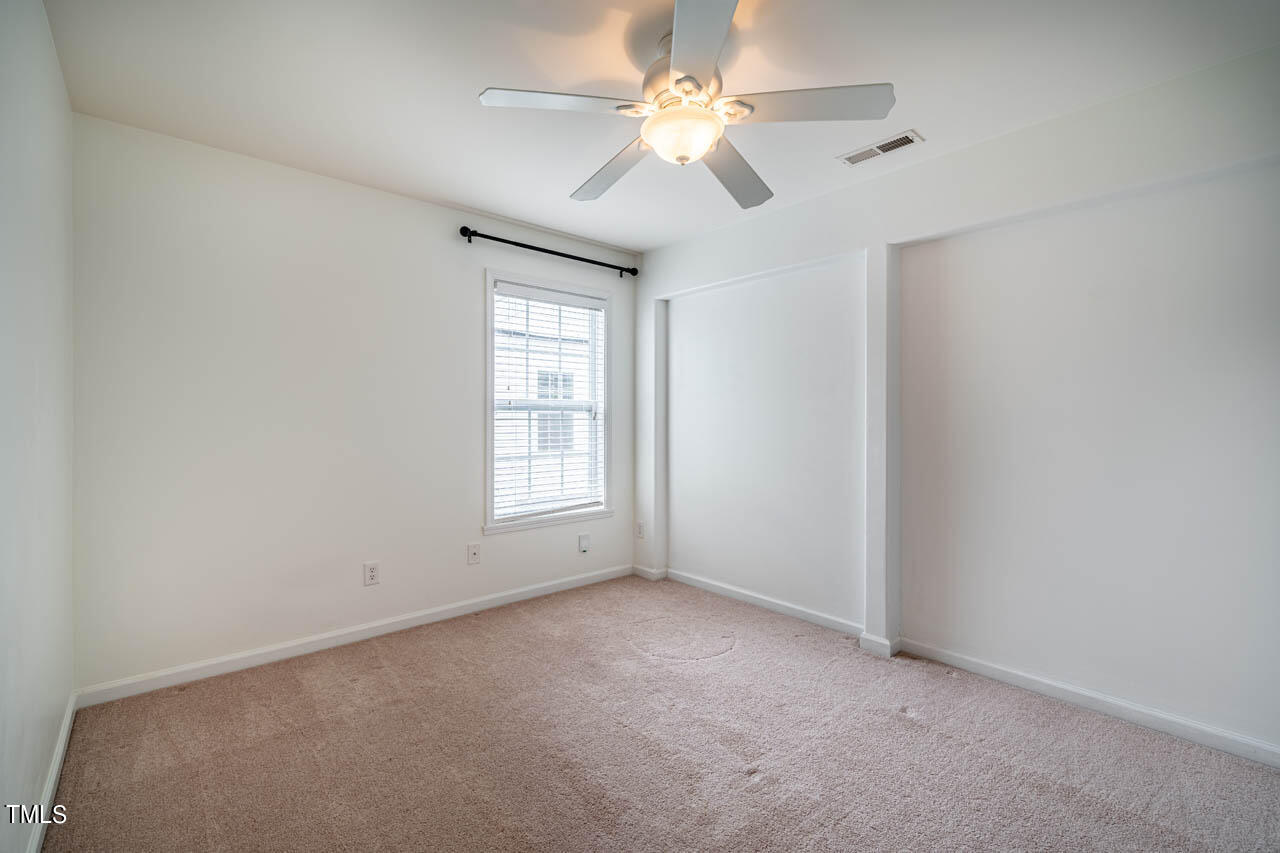 1314 Mallory Lane Durham, NC 27713 - Photo 39 of 47 an empty room with windows and ceiling fan